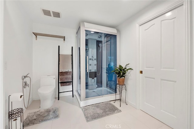 bathroom with toilet and tile patterned floors