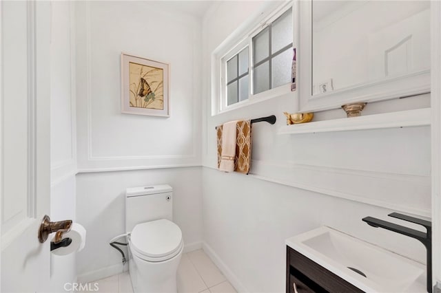 bathroom with toilet, tile patterned flooring, and vanity