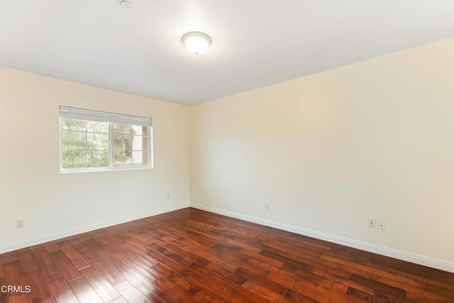 spare room with dark hardwood / wood-style flooring