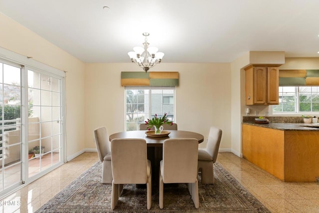 dining room with sink and an inviting chandelier