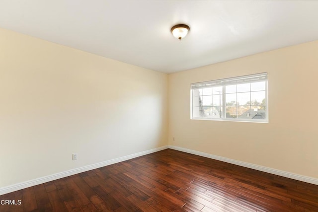 unfurnished room featuring dark wood-type flooring