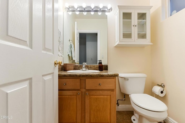 bathroom featuring toilet and vanity