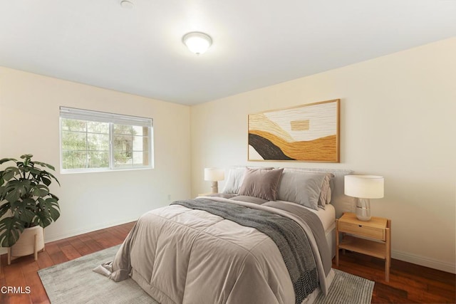 bedroom with dark hardwood / wood-style floors