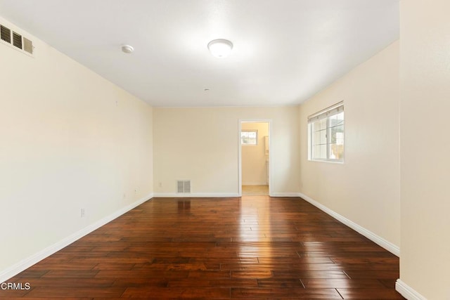 unfurnished room with dark hardwood / wood-style floors