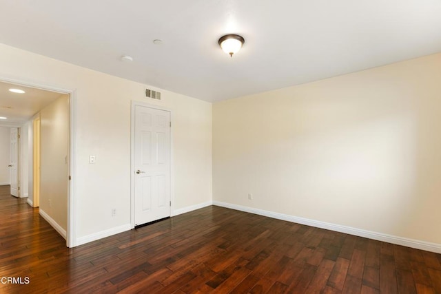 spare room featuring dark wood-type flooring