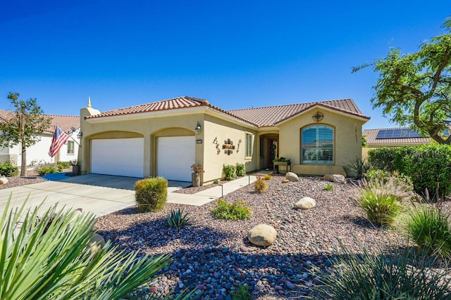 mediterranean / spanish-style home featuring a garage