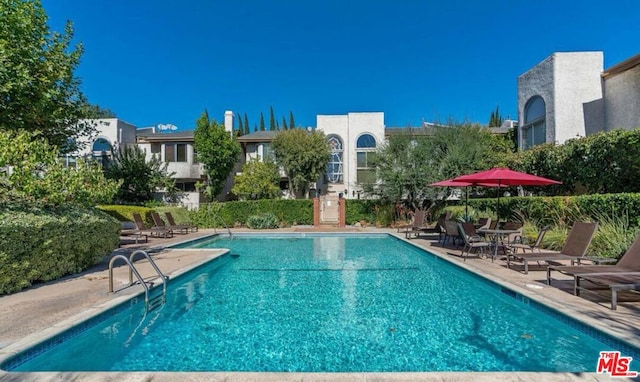 view of swimming pool featuring a patio area