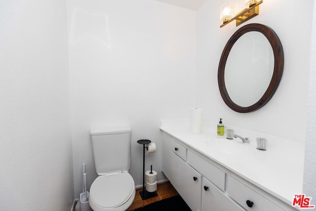 bathroom with toilet and vanity