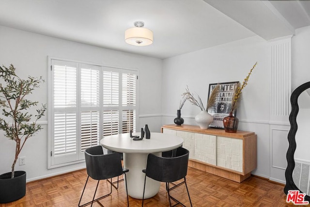 dining room featuring parquet floors