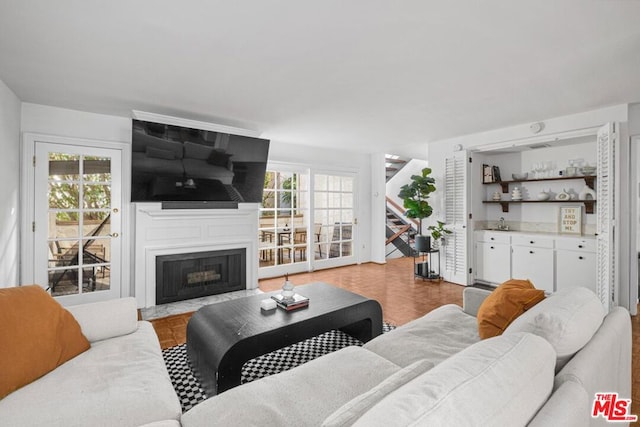 living room with a fireplace, light parquet flooring, and a wealth of natural light