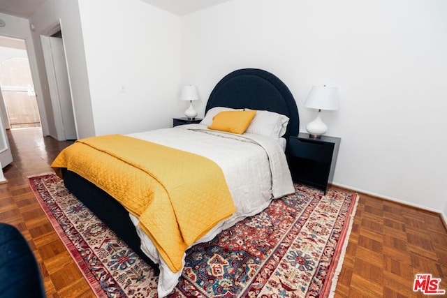 bedroom featuring parquet flooring