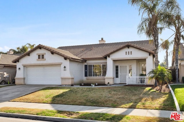 view of front of property with a garage and a front yard