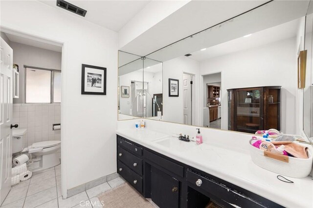 bathroom featuring tile patterned floors, vanity, and toilet