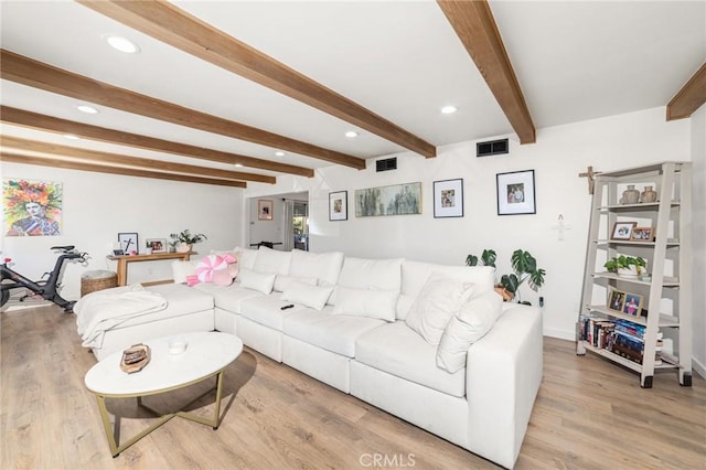 living room featuring light hardwood / wood-style flooring and beam ceiling