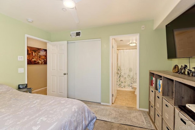 bedroom with a closet, connected bathroom, and ceiling fan