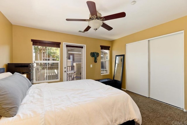 bedroom featuring dark colored carpet and ceiling fan