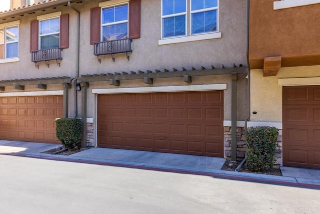 view of front of property with an attached garage and stucco siding