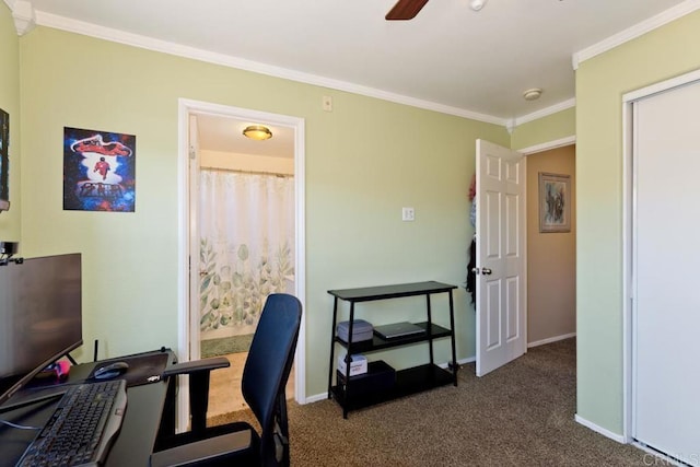 office area with ornamental molding, dark carpet, baseboards, and a ceiling fan