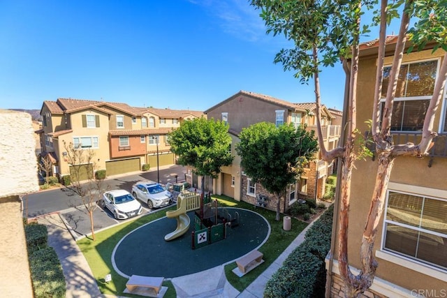 view of community featuring uncovered parking and a residential view