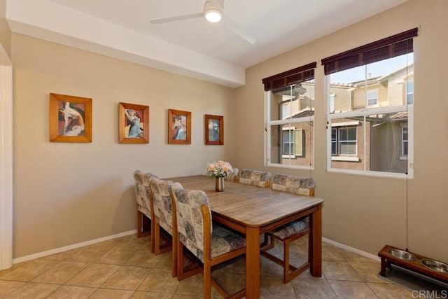 dining area featuring light tile patterned floors, ceiling fan, and baseboards