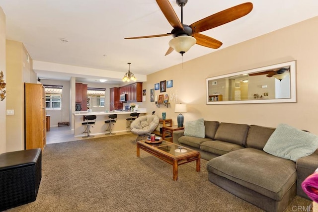 carpeted living room with a ceiling fan