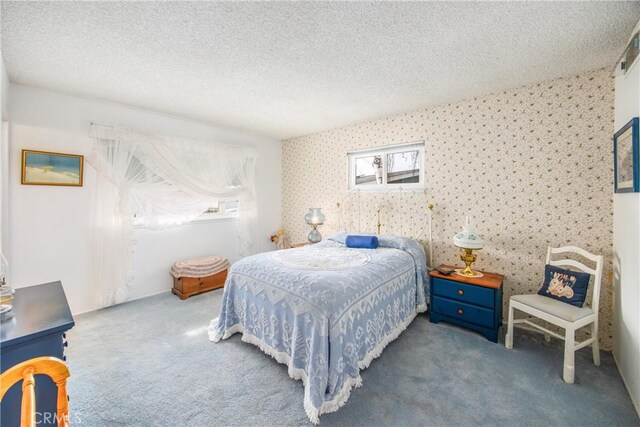 carpeted bedroom featuring a textured ceiling