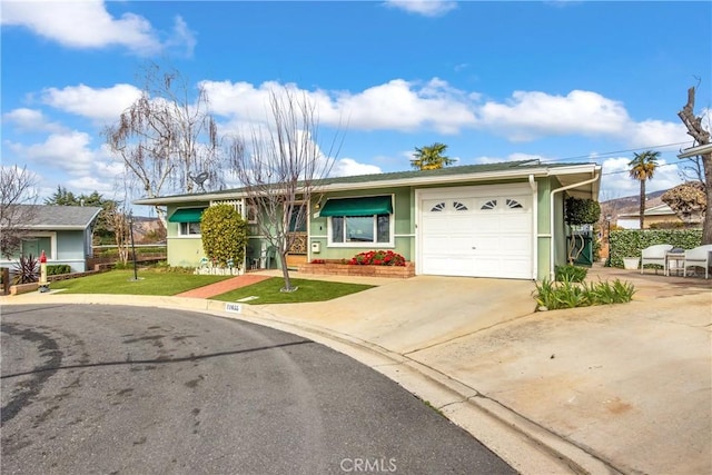 single story home featuring a front yard and a garage