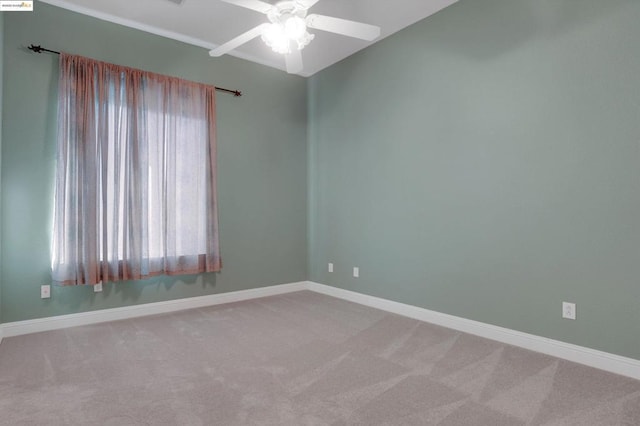 unfurnished room with ceiling fan and light carpet