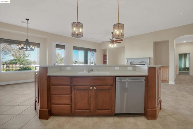 kitchen featuring sink, hanging light fixtures, a kitchen island with sink, and stainless steel dishwasher