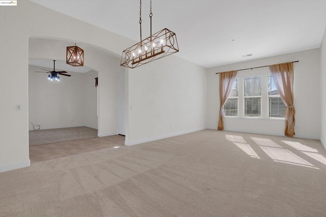 carpeted empty room featuring ceiling fan