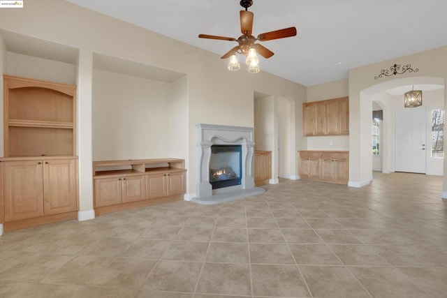 unfurnished living room with ceiling fan and light tile patterned floors