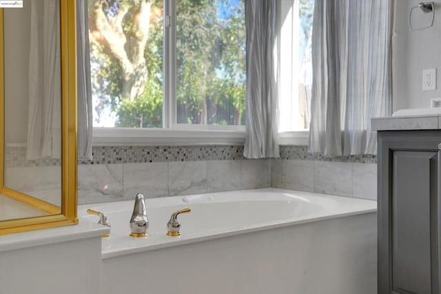 bathroom with a bathtub and vanity