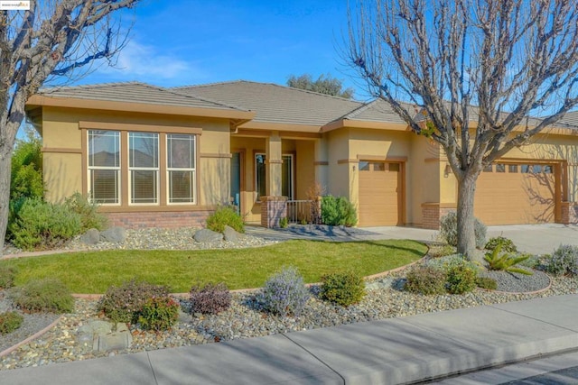 view of front of property featuring a garage and a front lawn