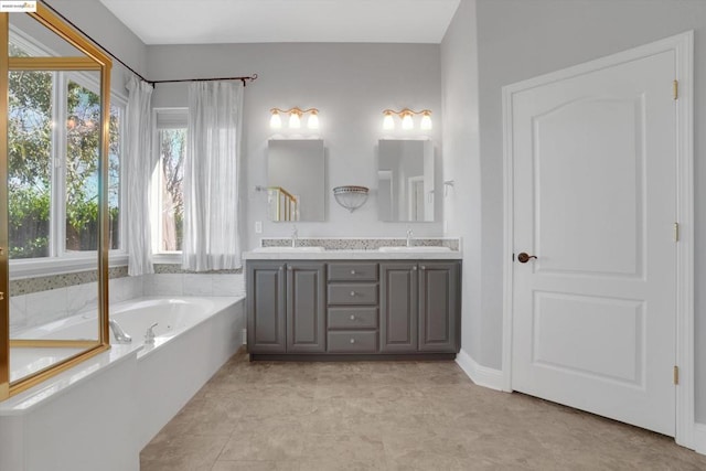 bathroom with vanity and a bath