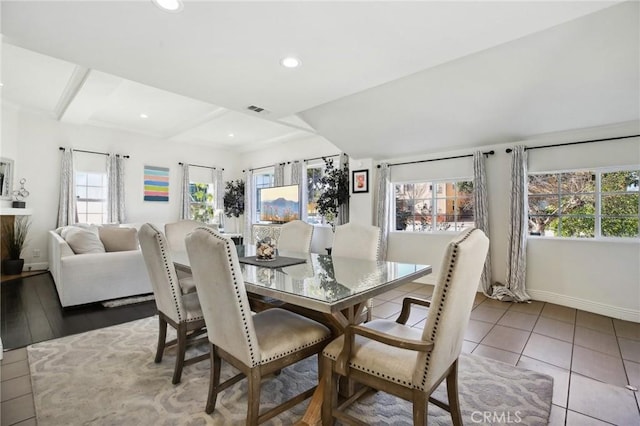 dining room featuring light tile patterned floors and beam ceiling