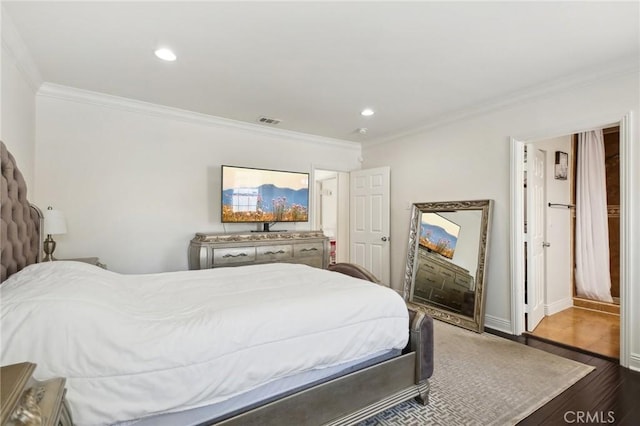 bedroom with visible vents, dark wood finished floors, recessed lighting, crown molding, and baseboards