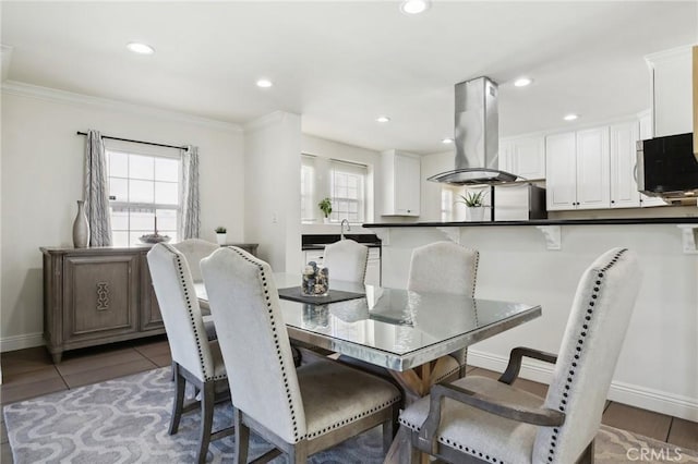 tiled dining room with recessed lighting, a healthy amount of sunlight, and baseboards