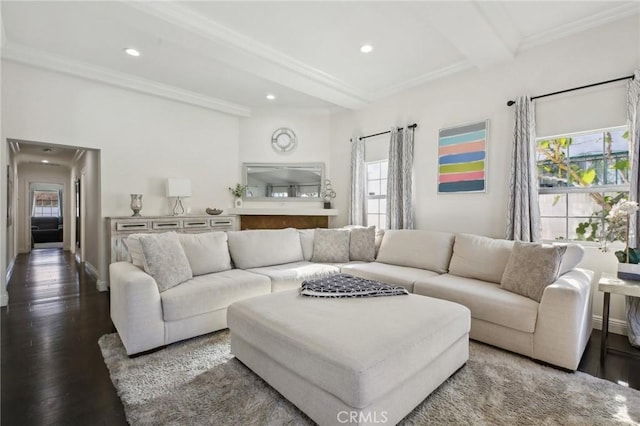 living area with beam ceiling, recessed lighting, ornamental molding, and wood finished floors