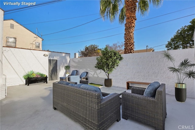 view of patio / terrace featuring an outdoor living space and a fenced backyard