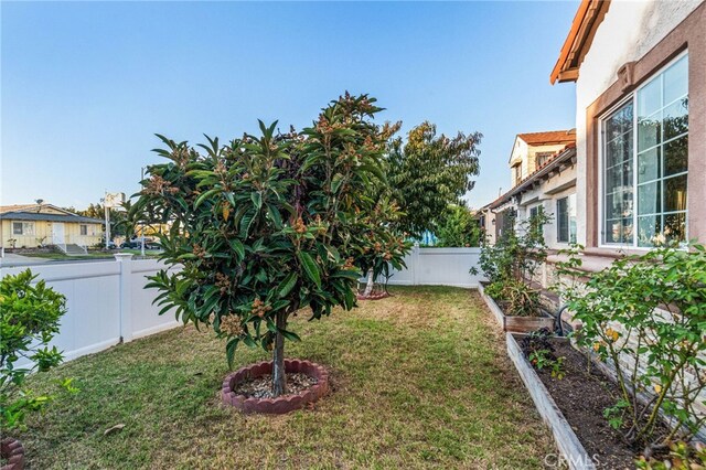 view of yard featuring a vegetable garden and a fenced backyard