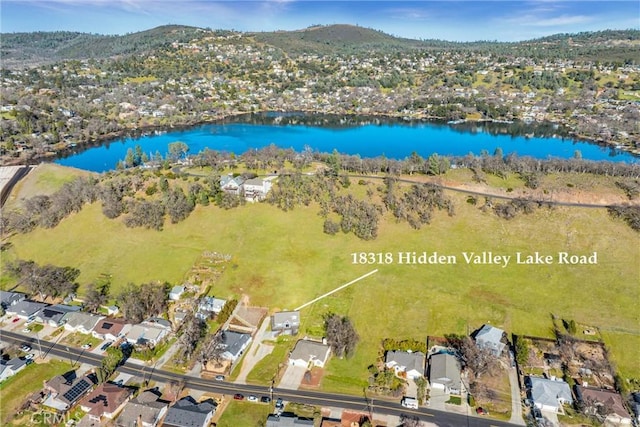 birds eye view of property with a water and mountain view