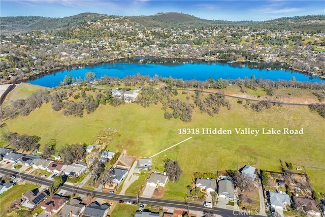 birds eye view of property with a residential view and a water and mountain view