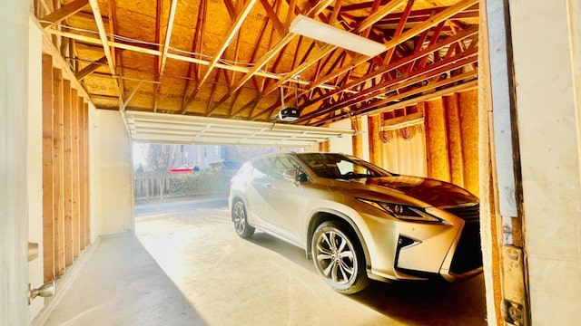 garage with a garage door opener and a carport