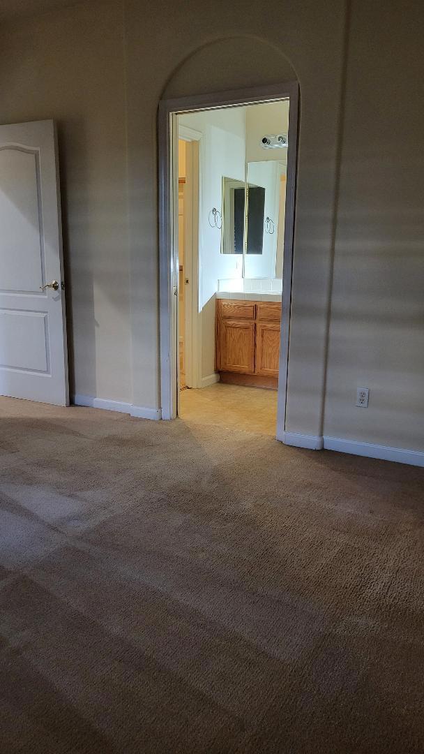 hall with light colored carpet