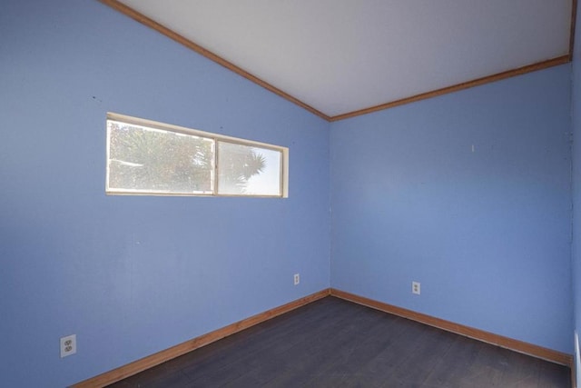 empty room with ornamental molding, dark hardwood / wood-style flooring, and lofted ceiling