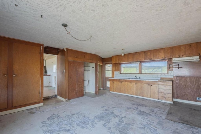 kitchen with sink and wood walls