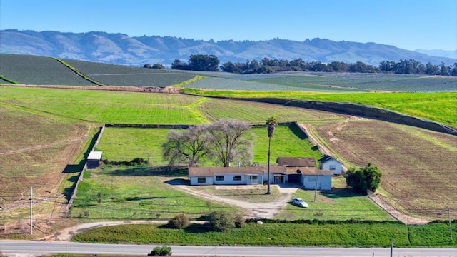 birds eye view of property featuring a water and mountain view and a rural view