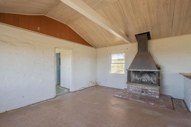 unfurnished living room with a wood stove, lofted ceiling with beams, and wood ceiling