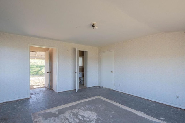 unfurnished room with lofted ceiling