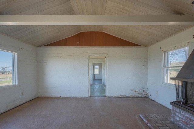 unfurnished living room featuring a healthy amount of sunlight and lofted ceiling with beams